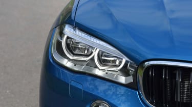 Circular LED daytime running lights help the X6 M to stand out, along with BMW&#039;s iconic kidney grille 