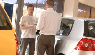 Car dealer and customer talking