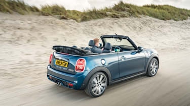 MINI Sidewalk Convertible driving on beach with roof down - rear view