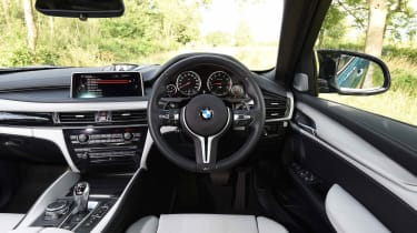 Standard leather upholstery, a sports steering wheel and unique gauges help set the X6 M apart from the regular version