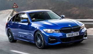 Blue BMW 3 Series driving