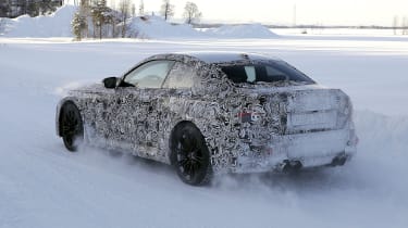 2022 BMW M2 spy shot rear corner driving snow