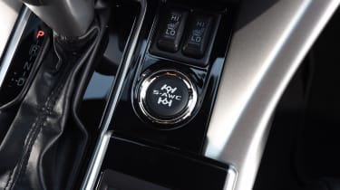 A big central control button changes the settings of the four-wheel drive system