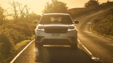 2021 Range Rover Velar P400e plug-in hybrid driving at sunset - front view