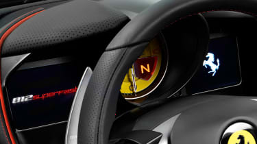 The dashboard screens are configurable, but dominated by a huge yellow dial