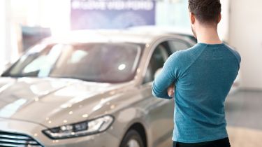 Man standing in front of car