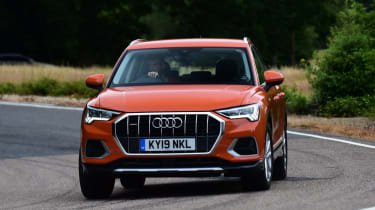 Orange Audi Q3 driving - front