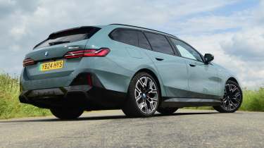 BMW i5 Touring low rear quarter static