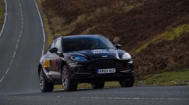 Aston Martin DBX prototype cornering on road - front view
