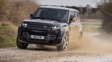 Land Rover Defender V8 90 driving on gravel
