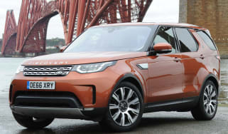 Land Rover Discovery parked next to bridge