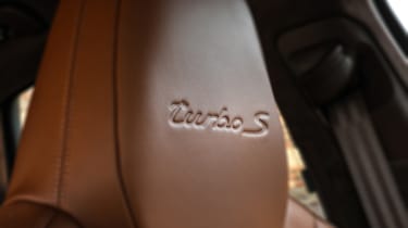 Porsche Cayenne Turbo S E-Hybrid turbo logo on seat
