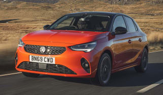 Orange Vauxhall Corsa driving