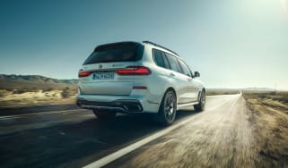 BMW X7 M50i rear view dynamic driving shot
