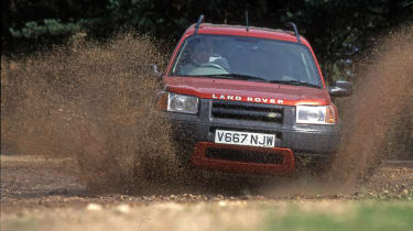 MK1 Land Rover Freelander driving through muddy river