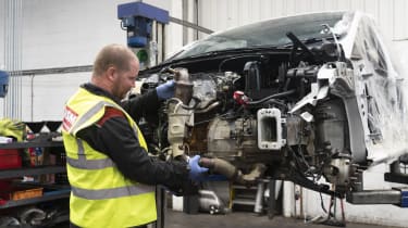 Mechanic dismantling car