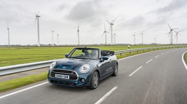 MINI Sidewalk Convertible driving on road in front of wind turbines