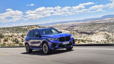 BMW X5 M Competition driving on road