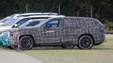 BMW X8 SUV in camouflage - side view