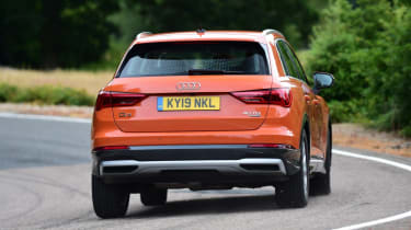 Orange Audi Q3 driving - rear
